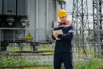 The energy engineer inspects the equipment of the substation. Power engineering. Industry.