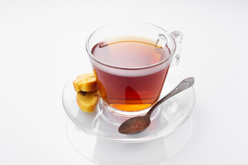 Black tea in a glass cup on a white background