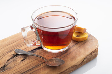 Black tea in a glass cup on a white background