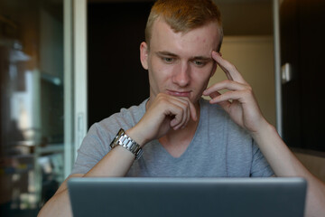 Portrait of young man with blond hair relaxing at home