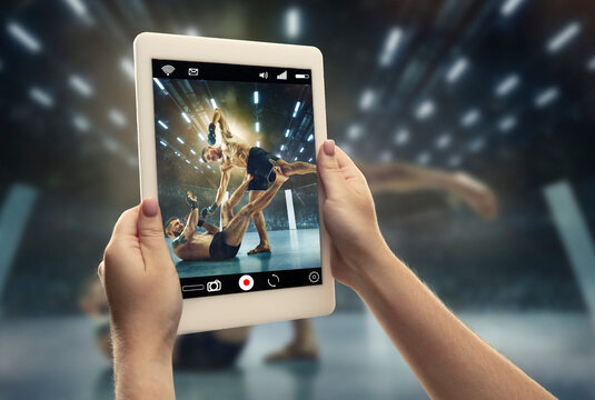 Close up hands holding tablet viewing sport, MMA online streaming of championship. New rules during coronavirus outbreak and countries lockdown. Concept of sport, competition, technologies.