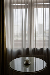 cup of morning coffee on a round marble table with different items