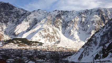 Gergeti Trinity Church at dawn in the snowy mountains near Stepantsminda, Georgia.
