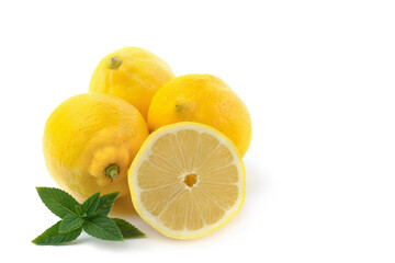 lemons whole and sliced, mint leaves, close-up on a white background, text space, horizontal view