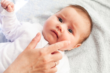 Baby with atopic dermatitis getting cream put. Care and Prevention Of Eczema.