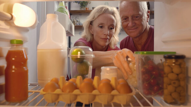 View Looking Out From Inside Of Refrigerator Mature Couple Food