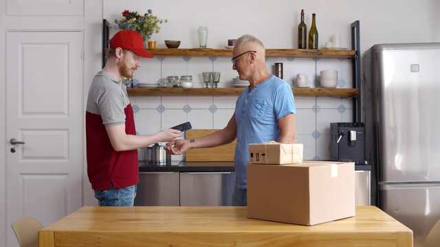 Delivery guy use cellphone for scanning qr-code on retired client wrist to pay for parcel - Powered by Adobe