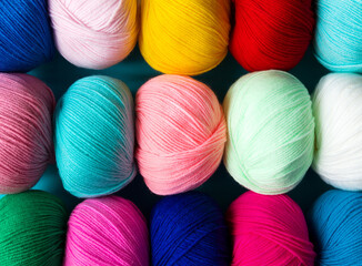 Colorful multicolored background from skeins of acrylic yarn. Textile industry.