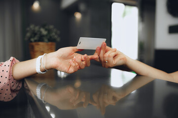 Hotel receptionist giving key-card to a client at front desk