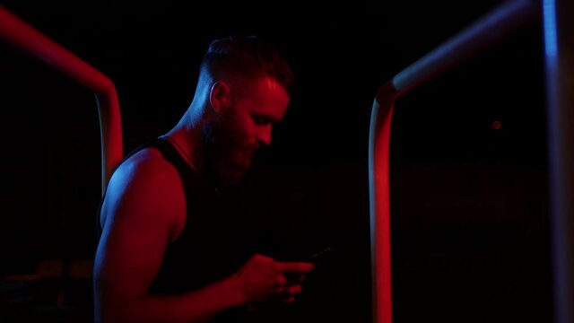 Athlete using a mobile phone at night