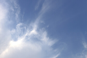 White clouds against blue sky background.