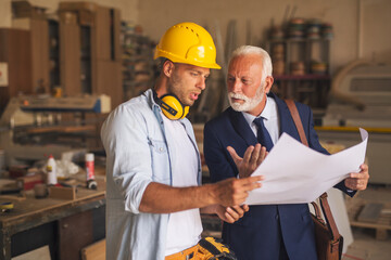 Project manager and joiner discussing about new project