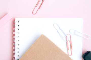 School stationery and supplies on a pink background with space for caption. Back to school, homeschool creative workspace. Minimalistic set of colorful stationery. Flat lay