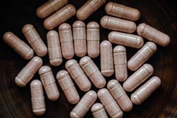 close-up of cranberry concentrate pills. dietary concept. dietary supplement topview.