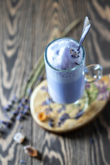 Hot latte, cappuccino with lavender on wooden table. Good Morning concept. Selective focus.