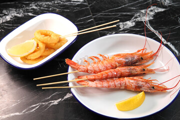 Beer pub. Seafood snack for beer. Langoustines, beer, squid rings.
