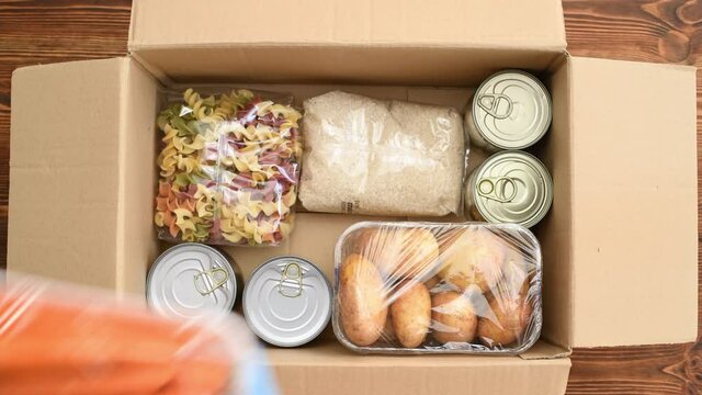 Groceries being packed in a box to be delivered, top view