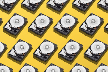 Broken hard disks pattern on isolated yellow background