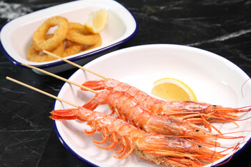 Beer pub. Seafood snack for beer. Langoustines, beer, squid rings.
