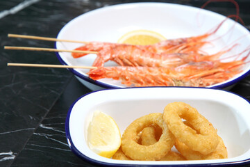 Beer pub. Seafood snack for beer. Langoustines, beer, squid rings.
