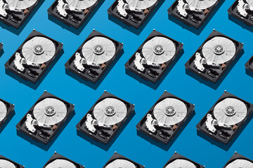 Broken hard disks pattern on isolated blue background