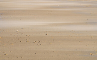 Sand moving over a Windblown Beach.  Suitable for a background, space for script.