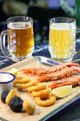 Beer pub. Langoustines and beer. Beer and seafood snacks. Langoustines, beer, squid rings. 