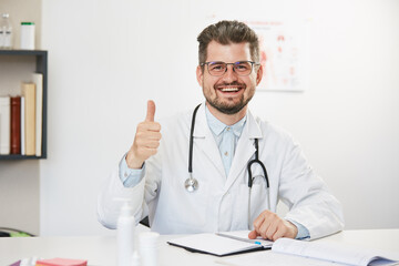 happy doctor showing thumb up gesture with smile on face