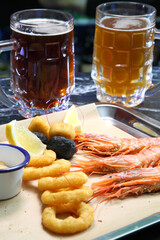 Beer pub. Langoustines and beer. Beer and seafood snacks. Langoustines, beer, squid rings. 