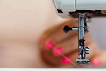 Fototapeta na wymiar Process of stitching on sewing machine close up view