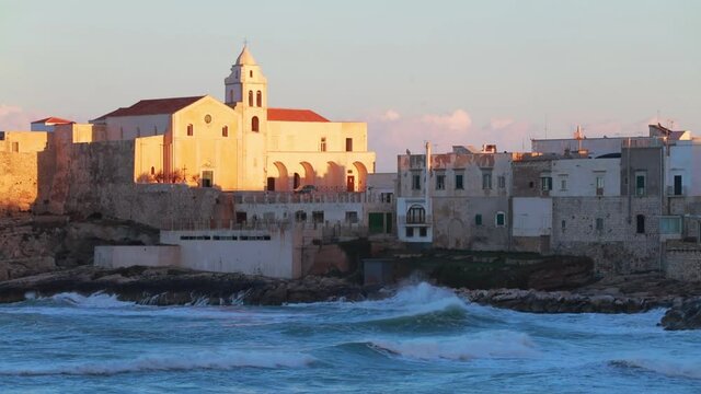 Amazing morning cityscape of Vieste - coastal town in Gargano National Park with Church of San Francesco, Italy, Europe. Stormy wether on Adriatic sea. Full HD video (High Definition).
