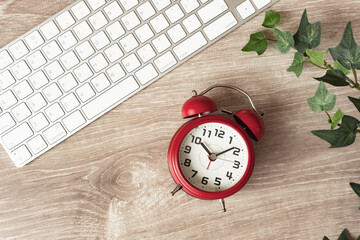 Computer and alarm clock. Work hours, working hours, telework, business, job changes, etc. Chic...