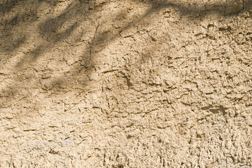Background, a natural sandstone wall on a seaside cliff. Sandstone overlay