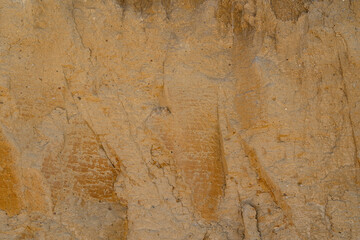 Background, a natural sandstone wall on a seaside cliff. Sandstone overlay