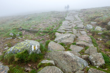 Fototapeta na wymiar turyści podczas wędrówki na górskim szlaku w czasie gęstej mgły.