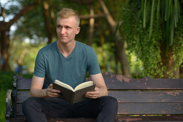 Fototapeta premium Young man with blond hair at the park outdoors