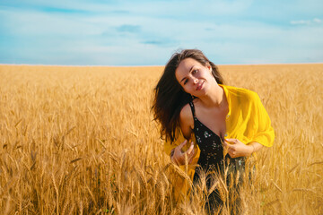 Young woman enjoying nature and sunlight in straw field