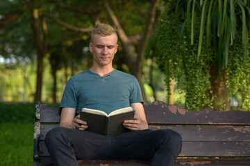 Young man with blond hair at the park outdoors