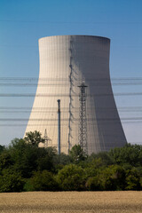 A cooling tower of a nuclear power plant. The high-voltage lines can be seen in the foreground.