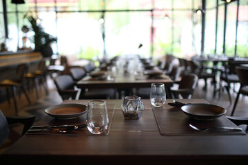 Table set with silverware dish and glass in restaurant