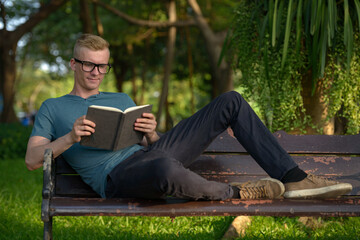 Fototapeta premium Young man with blond hair at the park outdoors