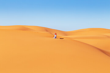 Beautiful girl in the Sahara desert.