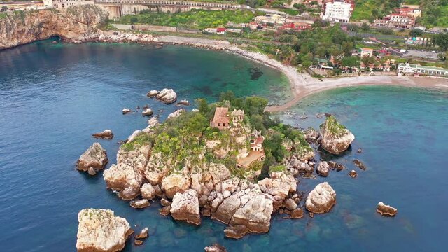 Breathtaking morning view of Bella island. Nice spring seascape of Mediterranean sea. Aerial view of Taormina town, Sicily, Itale, Europe. 4k drone forward video (Ultra High Definition).