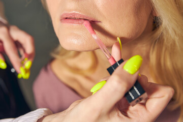 Close up of female hand holding lipstick