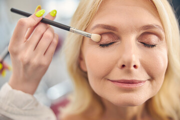 Portrait of pleased woman keeping her eyes closed