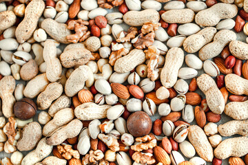 Assorted nuts for a background
Almond, walnut,cashew, pistachios, hazelnuts, peanuts, Macadamia
Collection of different varieties of nuts. Composition with dried fruits
Healthy food. Organic.