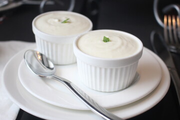 Close up of bowls of delicious durian puddings served on a white plate, soft focus