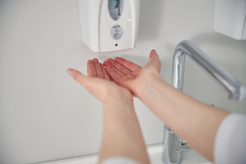 Close up of hands pouring down disinfector