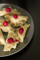 plate of pierogi with raspberries