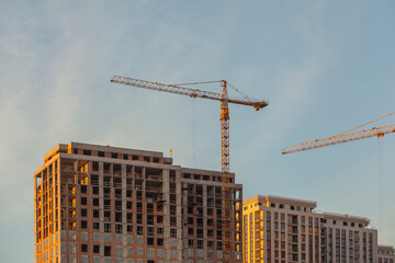 Fototapeta premium construction site with cranes against the blue sky